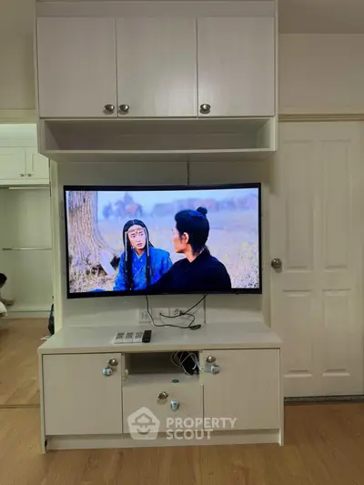 Modern living room with built-in TV cabinet and sleek wooden flooring