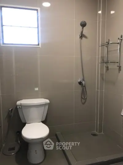 Modern bathroom with sleek shower and toilet design