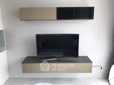 Modern living room with sleek TV unit and wall-mounted cabinets