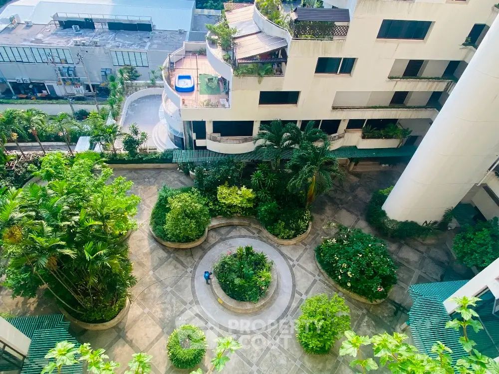 Stunning aerial view of lush garden courtyard in modern residential complex.