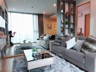 Luxurious modern living room with plush sofas and elegant decor, perfect for relaxation and entertainment.