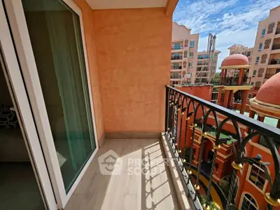 Charming balcony with elegant railing and scenic view of Mediterranean-style architecture.