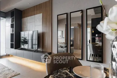 Modern living room with sleek TV unit and stylish mirrors, perfect for contemporary urban living.