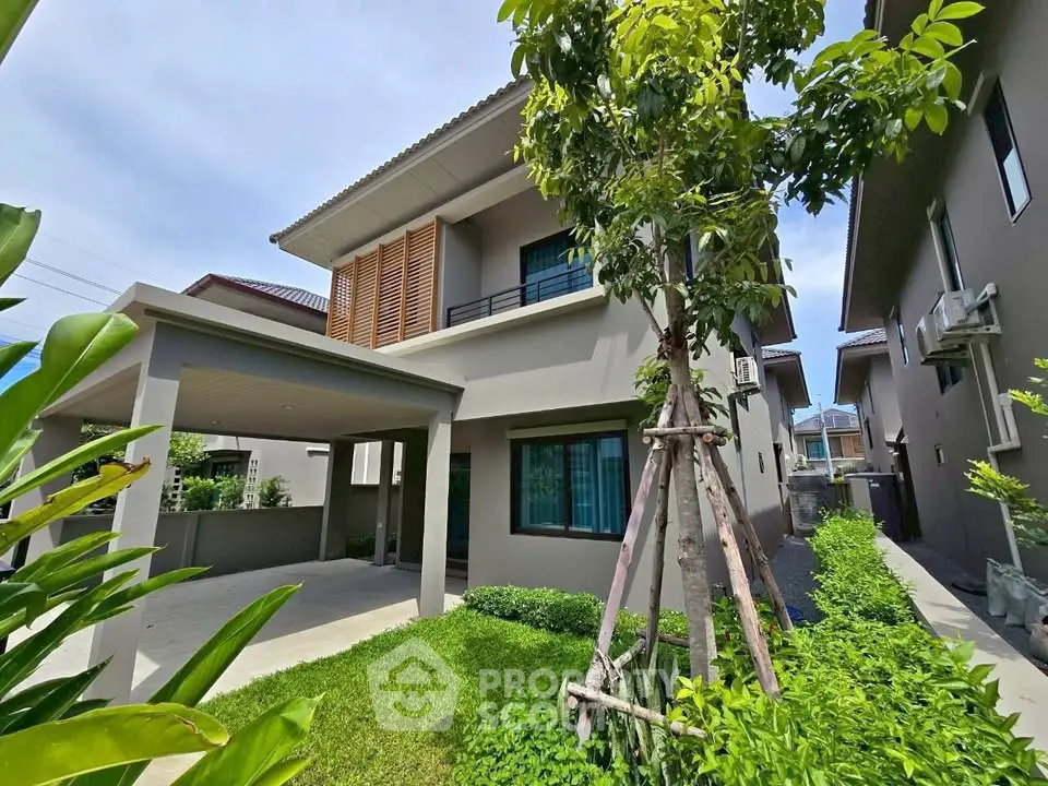 Modern two-story house with lush garden and spacious driveway