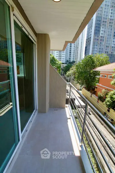 Spacious balcony with city view in modern apartment building