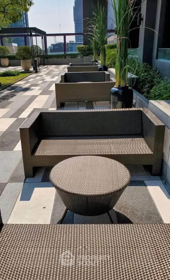 Luxurious rooftop terrace with modern outdoor seating and lush greenery, perfect for relaxation and entertainment.