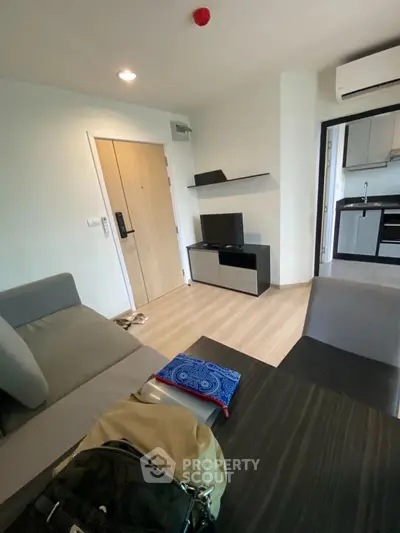 Modern living room with sleek furniture and open kitchen layout