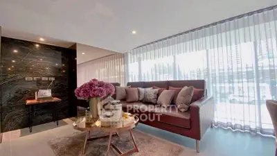 Luxurious living room with elegant decor and large windows offering city views.