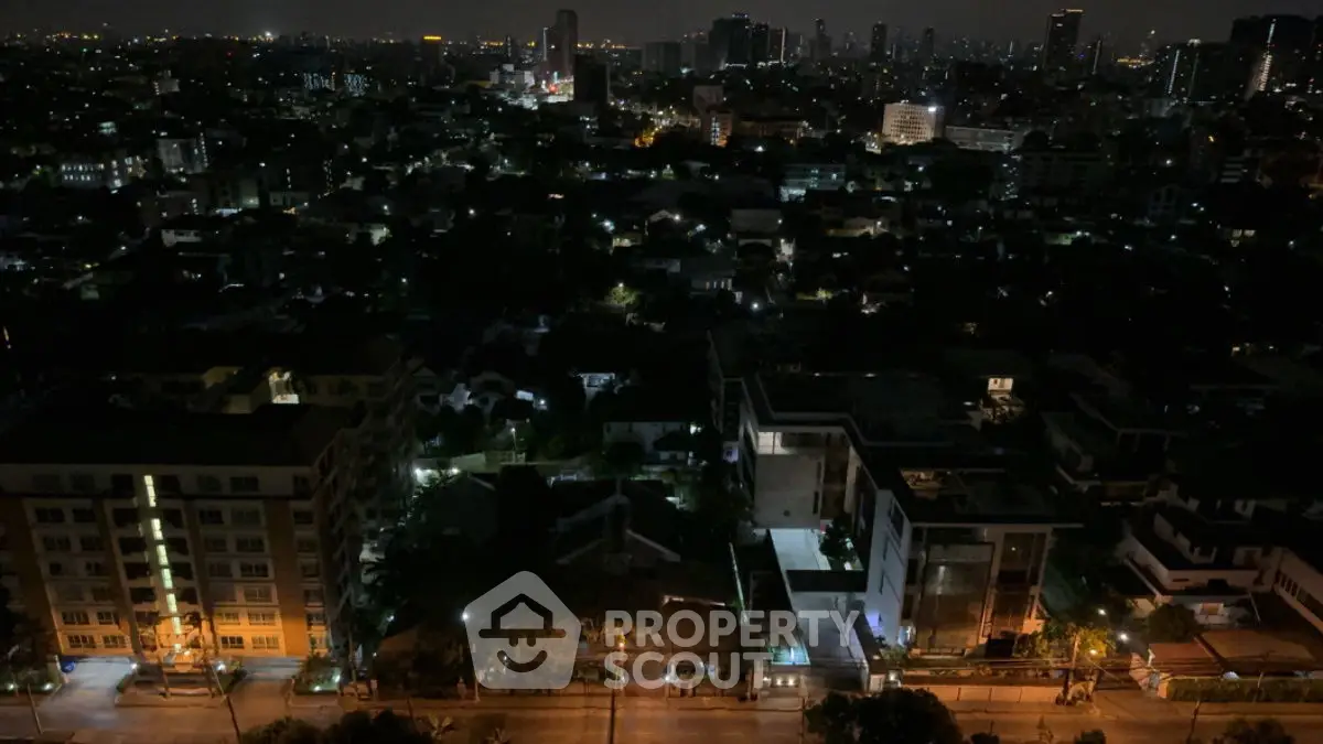 Stunning cityscape night view from high-rise building, showcasing vibrant urban lights and skyline.