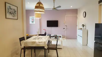 Charming open-plan living room with dining area, modern decor, and stylish lighting.