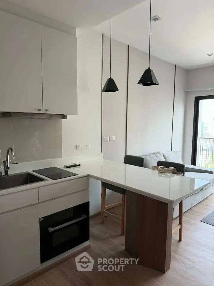 Modern open-layout kitchen with sleek design and cozy living area