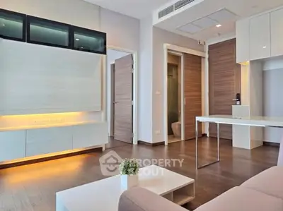 Modern living room with sleek design and open layout, featuring elegant wooden flooring and stylish furniture.