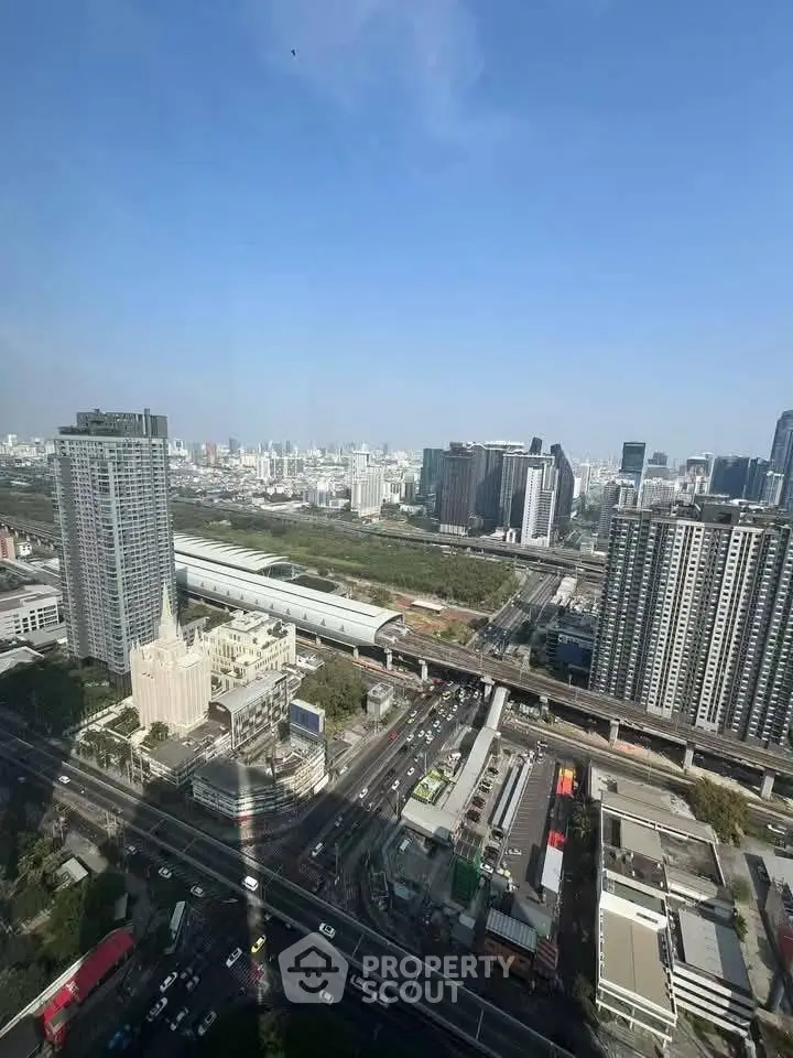 Stunning cityscape view from high-rise building showcasing urban skyline and transportation network.