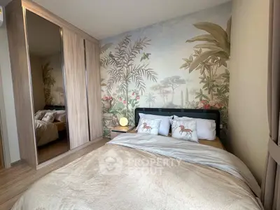 Charming bedroom with tropical-themed wallpaper and mirrored wardrobe, perfect for a cozy retreat.