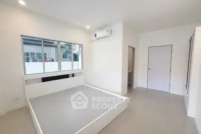 Spacious modern bedroom with large windows and minimalist design