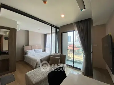 Modern studio apartment with large windows and city view