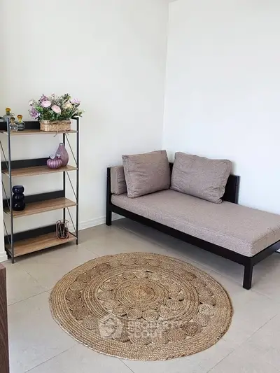 Cozy minimalist living room with stylish daybed and decorative shelving