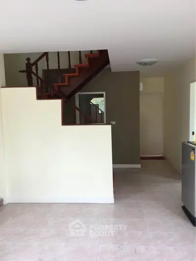 Spacious interior with staircase and tiled flooring, ideal for modern living.