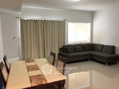 Spacious living room with modern dining set and cozy sectional sofa