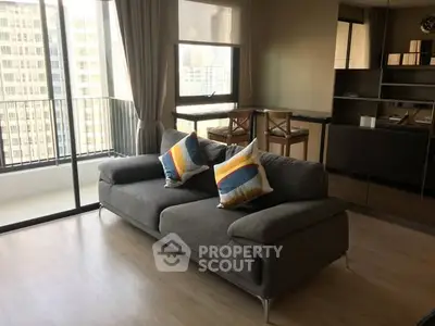 Modern living room with stylish sofa and balcony view in high-rise apartment