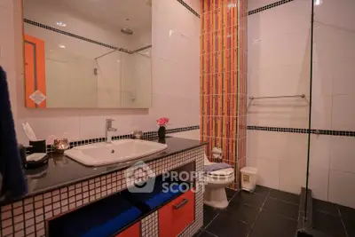 Modern bathroom with stylish sink and shower area in a contemporary home.