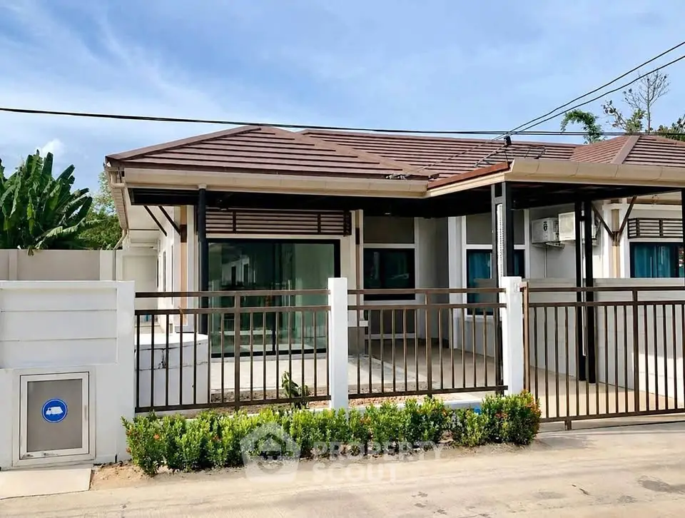 Charming single-story house with modern design and lush greenery in a serene neighborhood.