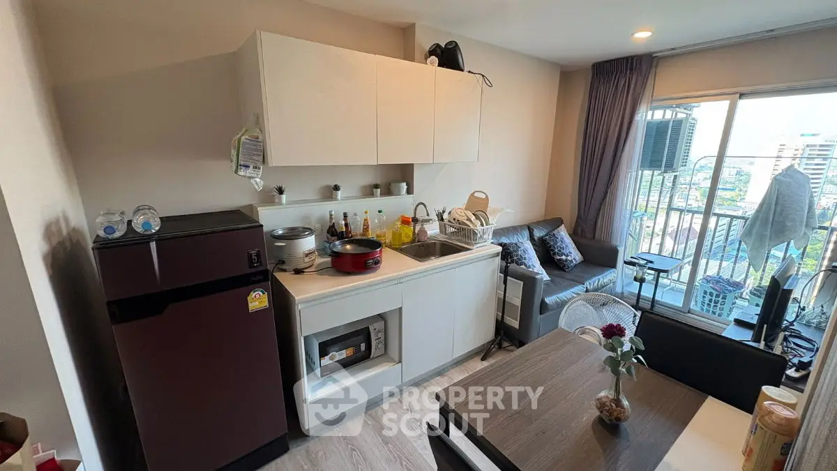 Modern compact kitchen with open layout and cozy living area in urban apartment