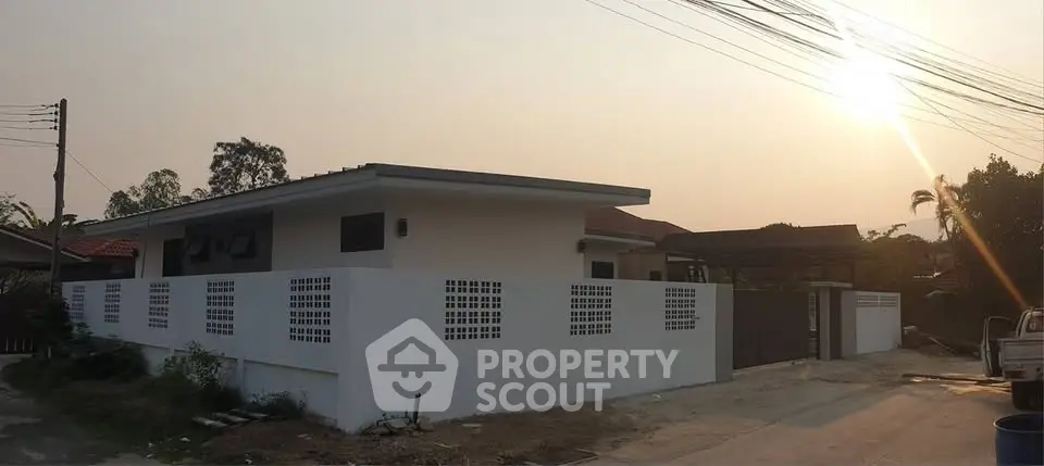 Modern single-story house with minimalist design and spacious outdoor area.