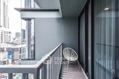 Modern urban balcony with city view, featuring sleek design and stylish chair for relaxation.