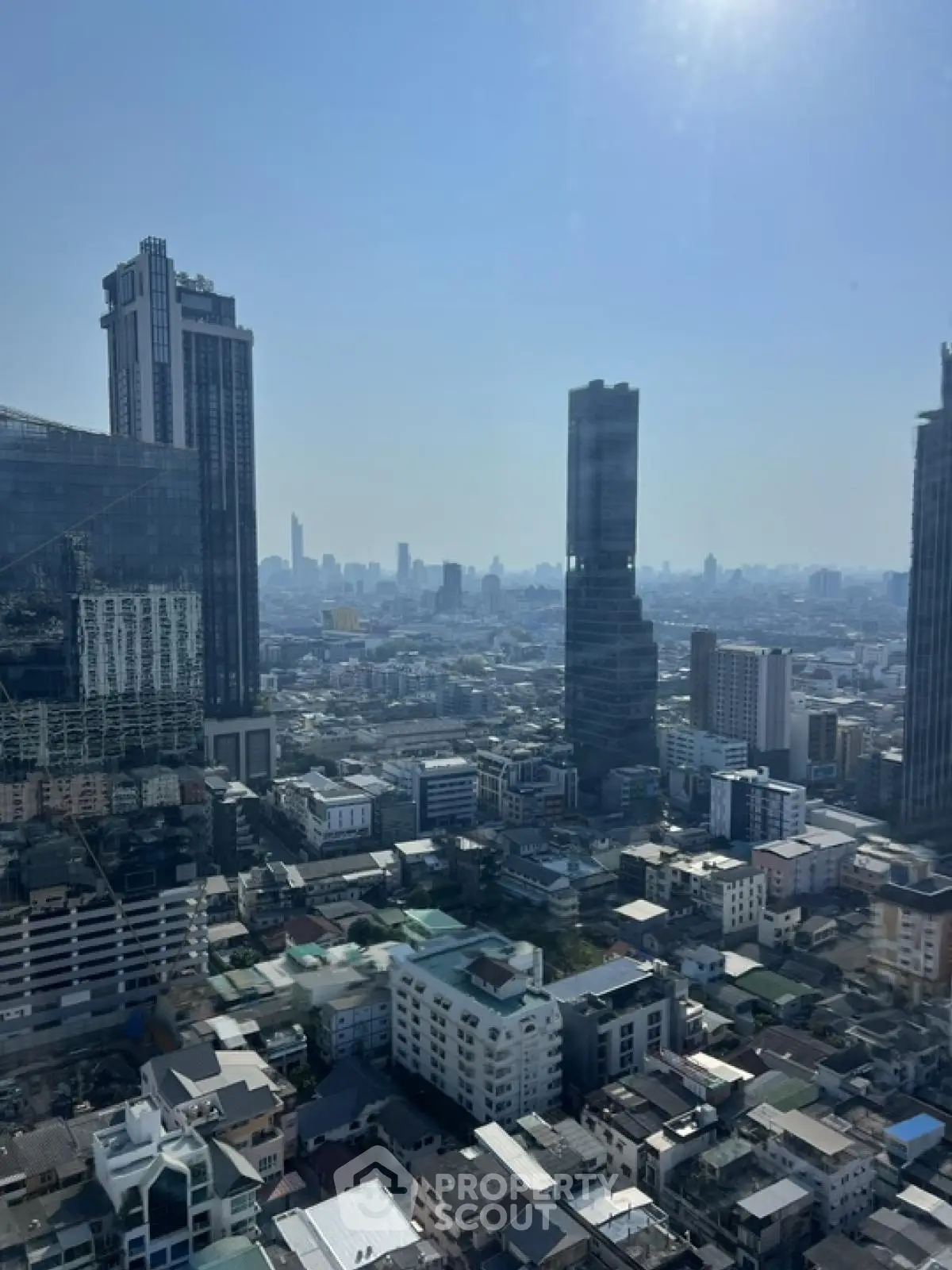 Stunning cityscape view showcasing modern skyscrapers and urban landscape under a clear blue sky.