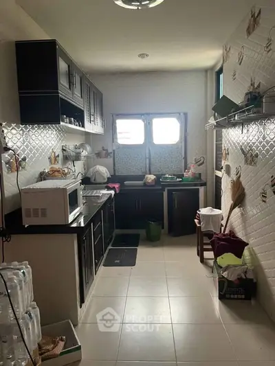 Cozy kitchen with closed layout and modern appliances, perfect for culinary enthusiasts.