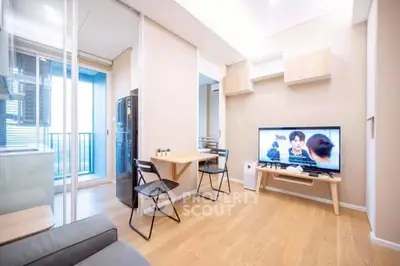 Modern living room with balcony access and TV setup
