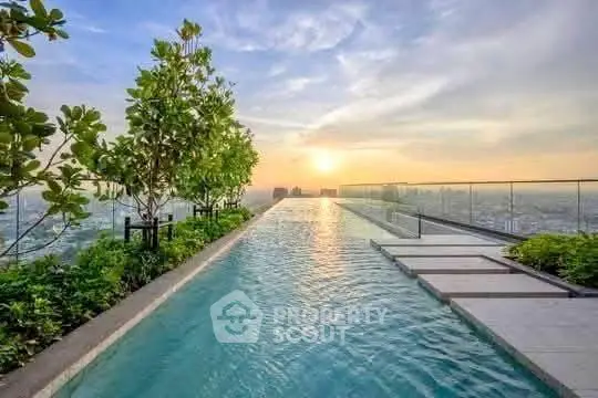 Stunning rooftop infinity pool with breathtaking city skyline views at sunset.