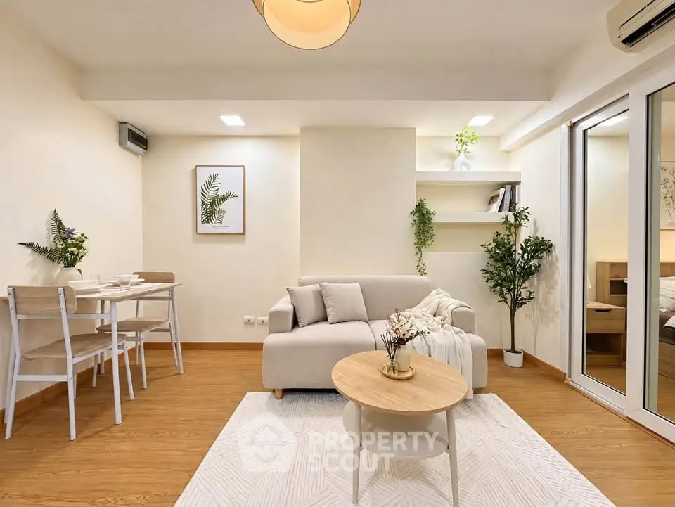 Charming living room with cozy sofa, dining area, and elegant decor in modern apartment.