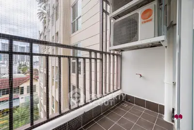 Modern balcony with safety netting and air conditioning unit in urban setting