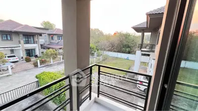 Charming balcony view overlooking suburban neighborhood with modern houses and lush greenery.