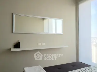 Modern minimalist bedroom with large mirror and natural light