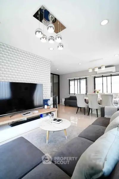 Modern living room with stylish decor and open dining area