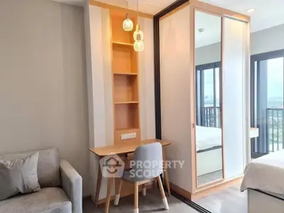 Modern bedroom with study area and balcony view