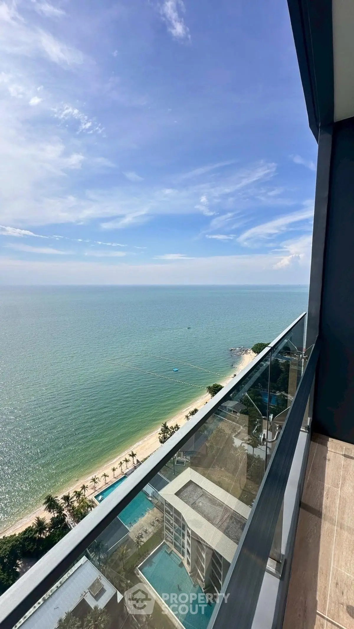 Stunning ocean view from high-rise balcony overlooking beach and horizon.