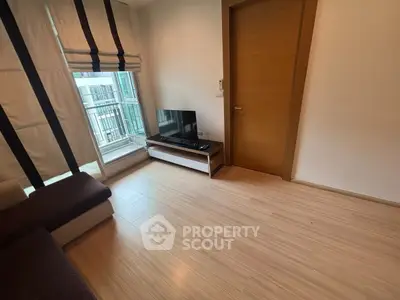 Modern living room with wooden flooring and natural light