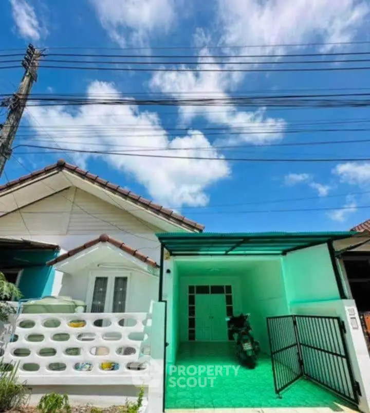 Charming single-story home with covered parking and vibrant exterior under a clear blue sky.