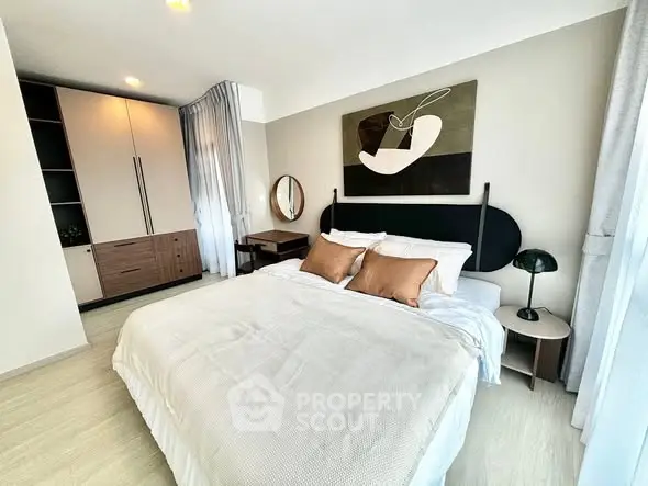 Modern bedroom with stylish decor and ample natural light