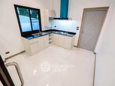 Modern kitchen with sleek design and gas stove in a bright, spacious layout.