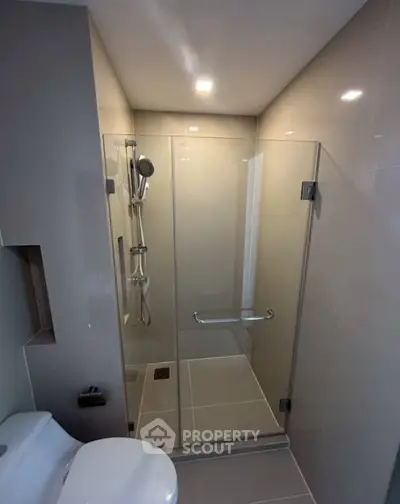 Modern bathroom with glass shower enclosure and sleek fixtures