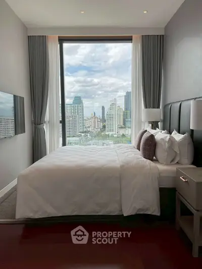 Luxurious bedroom with stunning city view through large window, modern decor and plush bedding.