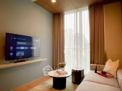 Modern living room with wall-mounted TV and cozy seating area