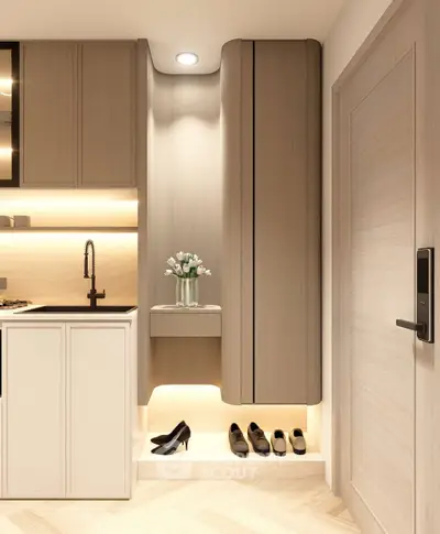 Modern kitchen with sleek cabinetry and elegant lighting, featuring a stylish shoe storage area.