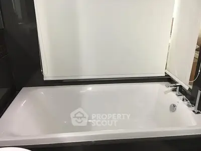 Modern bathroom with sleek bathtub and minimalist design