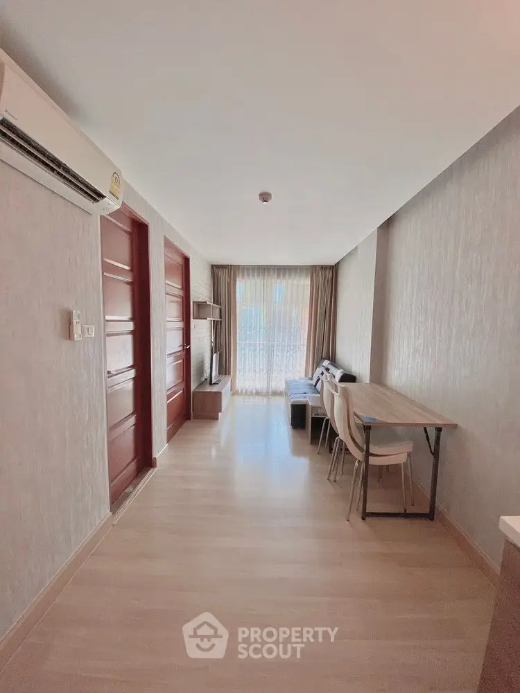 Modern living room with natural light and stylish furniture in a cozy apartment.